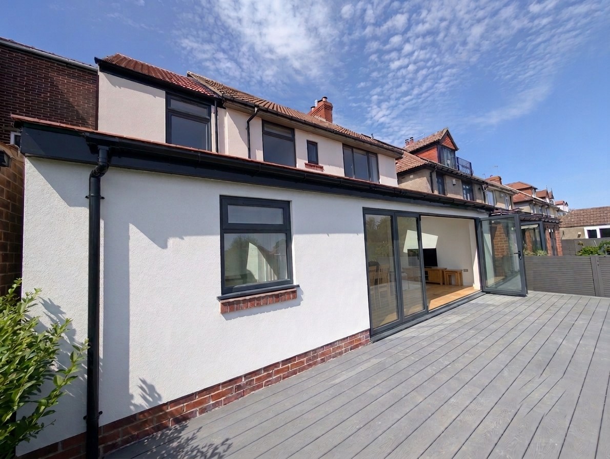 Rear house extension with bifold doors and composite decking, Sheffield